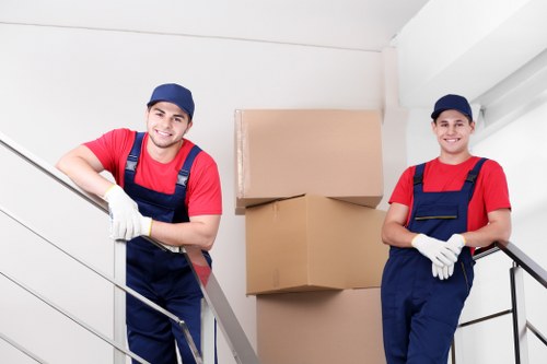 Professional movers loading household items for a West Green move
