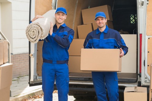 Packed furniture and boxes being loaded into a moving van