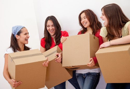 Packed office furniture ready for relocation near West Green