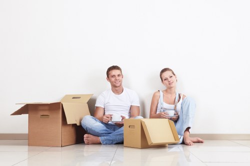 Local movers handling furniture in a West Green property