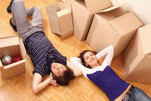 Professional movers handling furniture in a local West Green street
