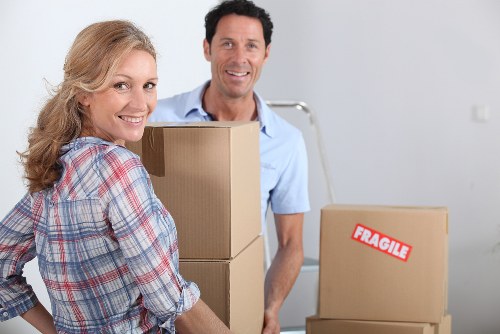 Professional moving team loading boxes and furniture into a van